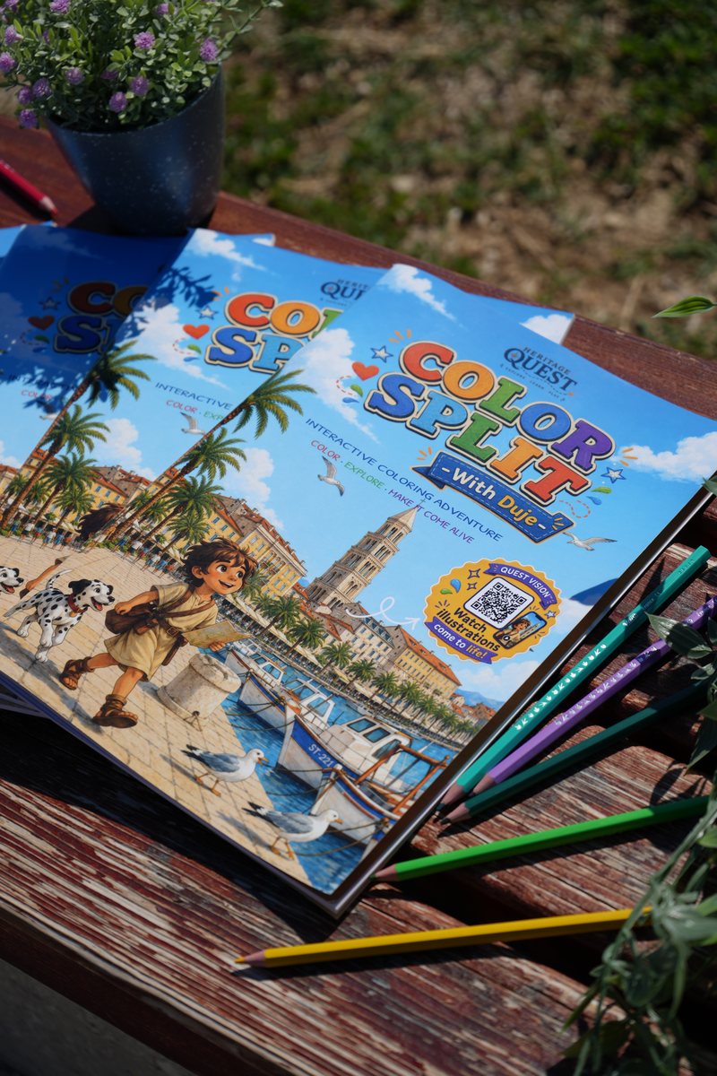 Copies of Color Split with Duje stacked on a wooden bench, the cover showing Duje and his dog on Split's waterfront, with coloured pencils and a flowering plant.