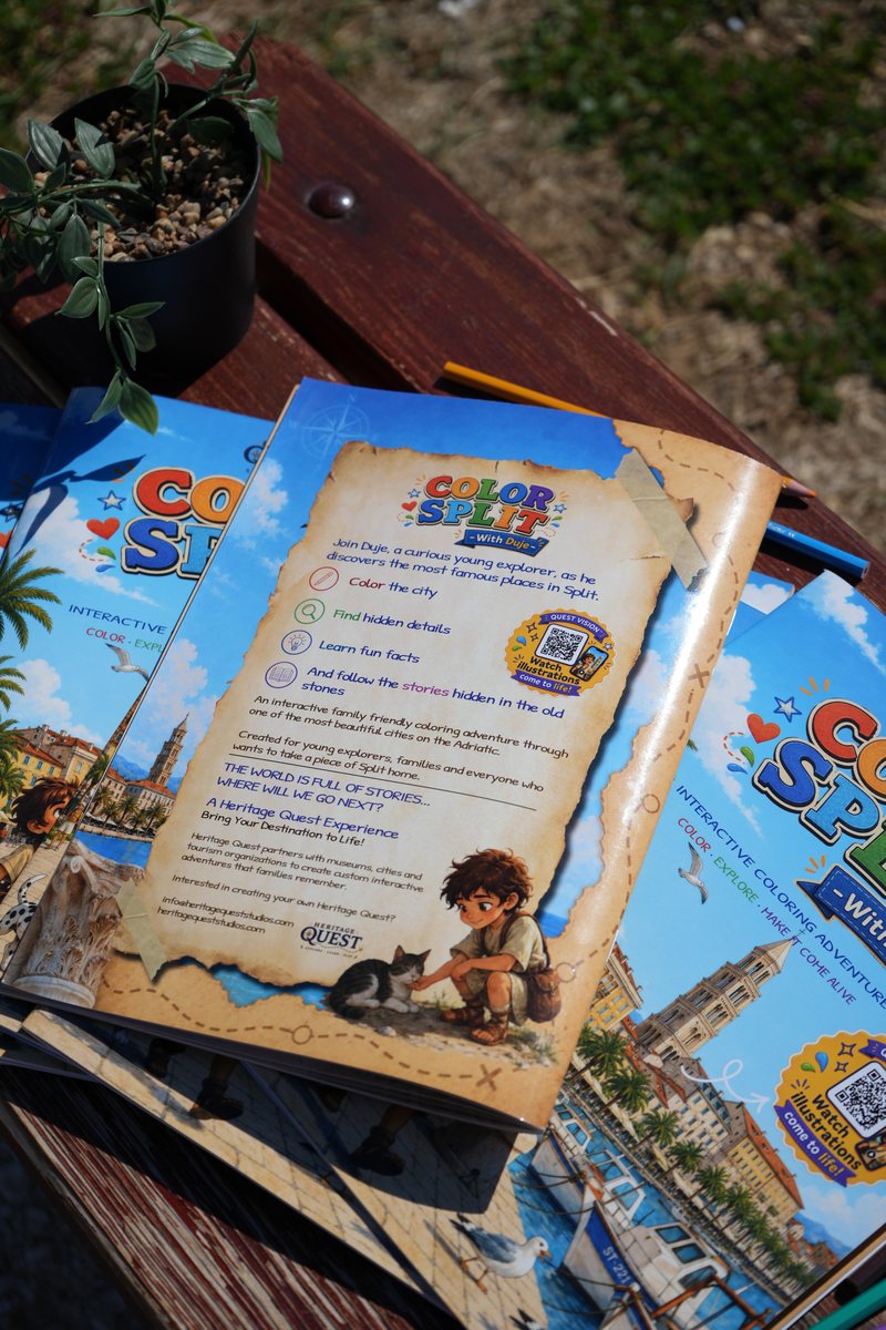 The back cover of Color Split with Duje resting on a stack of copies of the front cover, beside a potted plant.